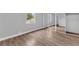 Spacious bedroom with mirrored closet and wood-look flooring at 1502 Ne Buckeye Ne Rd # 2, Winter Haven, FL 33881