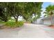 Community view with mature trees and garages at 1502 Ne Buckeye Ne Rd # 2, Winter Haven, FL 33881