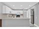 Modern kitchen with white cabinets and a breakfast bar at 1502 Ne Buckeye Ne Rd # 2, Winter Haven, FL 33881
