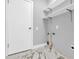 Modern laundry room with white cabinets and marble-look flooring at 1502 Ne Buckeye Ne Rd # 2, Winter Haven, FL 33881
