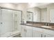 Bathroom with double vanity, granite countertop, and a large walk-in shower at 2638 Galway Grove Way, Lakeland, FL 33811