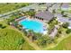 Community pool with lounge chairs, a clubhouse, and landscaping at 2638 Galway Grove Way, Lakeland, FL 33811