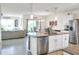 Open kitchen with island, stainless steel appliances, and views to the living room at 2638 Galway Grove Way, Lakeland, FL 33811