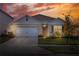 One-story home with a two-car garage, landscaping, and neutral exterior at 2638 Galway Grove Way, Lakeland, FL 33811