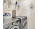 Laundry room with washer, dryer, and storage at 2638 Galway Grove Way, Lakeland, FL 33811