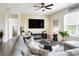 Relaxing living room featuring a sectional sofa, fireplace, and large TV at 2638 Galway Grove Way, Lakeland, FL 33811