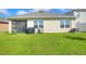 Spacious backyard with grassy lawn and screened patio at 2638 Galway Grove Way, Lakeland, FL 33811