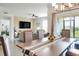 Dining room with table, chairs, and view into living room and backyard at 2638 Galway Grove Way, Lakeland, FL 33811