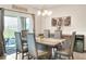 Bright dining room featuring a wood table, six chairs, and access to a patio at 2638 Galway Grove Way, Lakeland, FL 33811