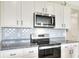 Modern kitchen with stainless steel appliances and granite countertops at 2638 Galway Grove Way, Lakeland, FL 33811