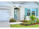 Inviting front entrance with a covered porch and landscaping at 2638 Galway Grove Way, Lakeland, FL 33811