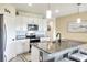 Modern kitchen with white cabinets, granite countertops, and stainless steel appliances at 2638 Galway Grove Way, Lakeland, FL 33811