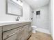 Updated bathroom with gray tile shower and wood vanity at 227 W 7Th St, Apopka, FL 32703