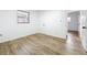 Simple bedroom with wood-look floors and access to another room at 227 W 7Th St, Apopka, FL 32703