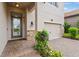 Exterior view of house entrance with double garage and stone accents at 4227 Prima Lago Dr, Lakeland, FL 33810