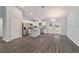 Modern kitchen with island, stainless steel appliances, and gray flooring at 6319 Nw 67 Ter, Ocala, FL 34482