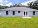Rear view of house with patio and grassy yard at 6319 Nw 67 Ter, Ocala, FL 34482