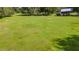 Expansive green pasture with a home and barn in the background at 4292 Sw 73Rd Trl, Bushnell, FL 33513