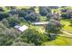 Aerial view of a house and barn on a large lot, surrounded by trees and green space at 4292 Sw 73Rd Trl, Bushnell, FL 33513