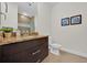 Clean bathroom with dark vanity, granite countertop and shower at 17531 Placidity Ave, Clermont, FL 34714