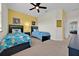 Two twin beds in a well-lit bedroom with yellow accent wall at 17531 Placidity Ave, Clermont, FL 34714