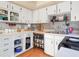White kitchen with wood-look flooring and ample counter space at 5337 Jacob Ave, Polk City, FL 33868