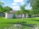 Gray house with a green lawn and palm trees at 5337 Jacob Ave, Polk City, FL 33868