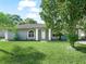Gray house with a green lawn and palm trees at 5337 Jacob Ave, Polk City, FL 33868