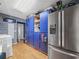 Kitchen features blue cabinets and stainless steel refrigerator at 5337 Jacob Ave, Polk City, FL 33868