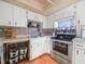 White kitchen with wood-look flooring and ample counter space at 5337 Jacob Ave, Polk City, FL 33868