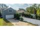 Gray house exterior with white garage door at 7036 Mapperton Dr, Windermere, FL 34786