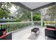 Inviting front porch with wicker furniture and view of trees at 7036 Mapperton Dr, Windermere, FL 34786