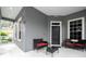 Front porch with black wicker furniture at 7036 Mapperton Dr, Windermere, FL 34786