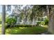 Gray house with white porch and landscaping at 7036 Mapperton Dr, Windermere, FL 34786