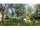 Gray house with white porch and landscaping at 7036 Mapperton Dr, Windermere, FL 34786