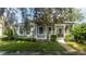Gray house with white porch and landscaping at 7036 Mapperton Dr, Windermere, FL 34786