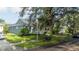 Gray house with landscaping and street view at 7036 Mapperton Dr, Windermere, FL 34786