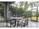 Enjoy this screened patio with table and chairs for outdoor dining at 7036 Mapperton Dr, Windermere, FL 34786