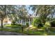 Gray house with white porch and landscaping at 7036 Mapperton Dr, Windermere, FL 34786
