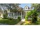 Gray house with white porch and landscaping at 7036 Mapperton Dr, Windermere, FL 34786