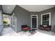 Front porch with seating area and entry door at 7036 Mapperton Dr, Windermere, FL 34786