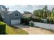Gray house with white garage and side yard at 7036 Mapperton Dr, Windermere, FL 34786
