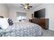 Bedroom with a large TV, queen bed, and ceiling fan at 7036 Mapperton Dr, Windermere, FL 34786