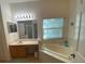 Bathroom with double sinks and a large garden tub at 24502 Parlange Ct, Leesburg, FL 34748