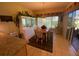 Bright dining area with table, chairs, and built-in hutch, offering access to a relaxing patio at 24502 Parlange Ct, Leesburg, FL 34748