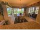 Bright dining area with table, chairs, and built-in hutch, offering access to a relaxing patio at 24502 Parlange Ct, Leesburg, FL 34748