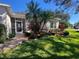 Landscaped entryway to a single Gathering home at 24502 Parlange Ct, Leesburg, FL 34748