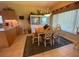 Bright dining area with table, chairs, and built-in hutch, offering access to a relaxing patio at 24502 Parlange Ct, Leesburg, FL 34748