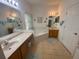 Bathroom with double sinks, garden tub, and separate shower at 24502 Parlange Ct, Leesburg, FL 34748