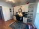 Spacious home office with built-in cabinetry and wood floors at 24502 Parlange Ct, Leesburg, FL 34748